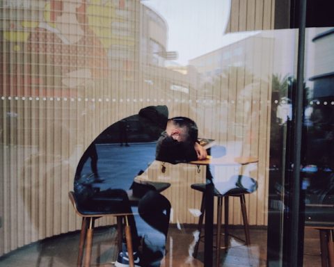 Guy sleeping on his computer