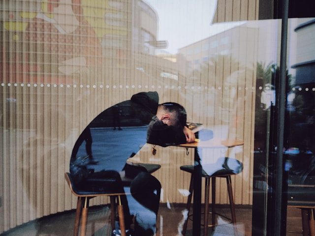Guy sleeping on his computer