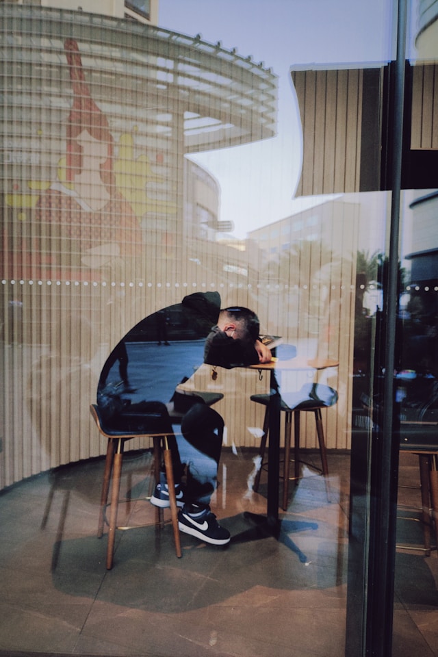 Guy sleeping on his computer