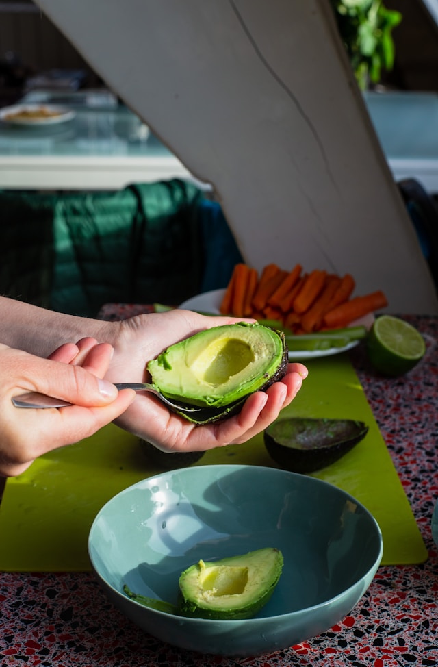 Picture of someone eating an avocado